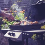 Senior man cooking meat on barbecue