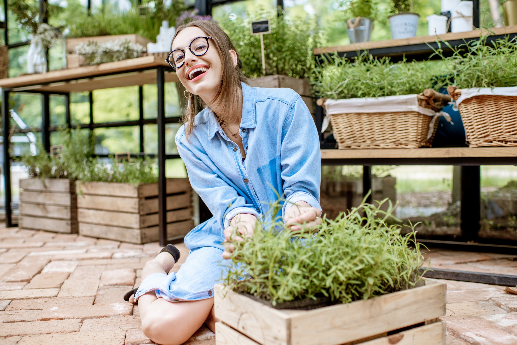 Woman with herbs in the greenhouse