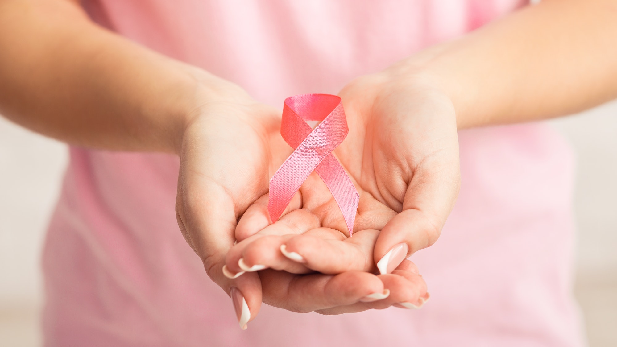 Unrecognizable Woman Showing Pink Breast Cancer Ribbon, White Background, Panorama