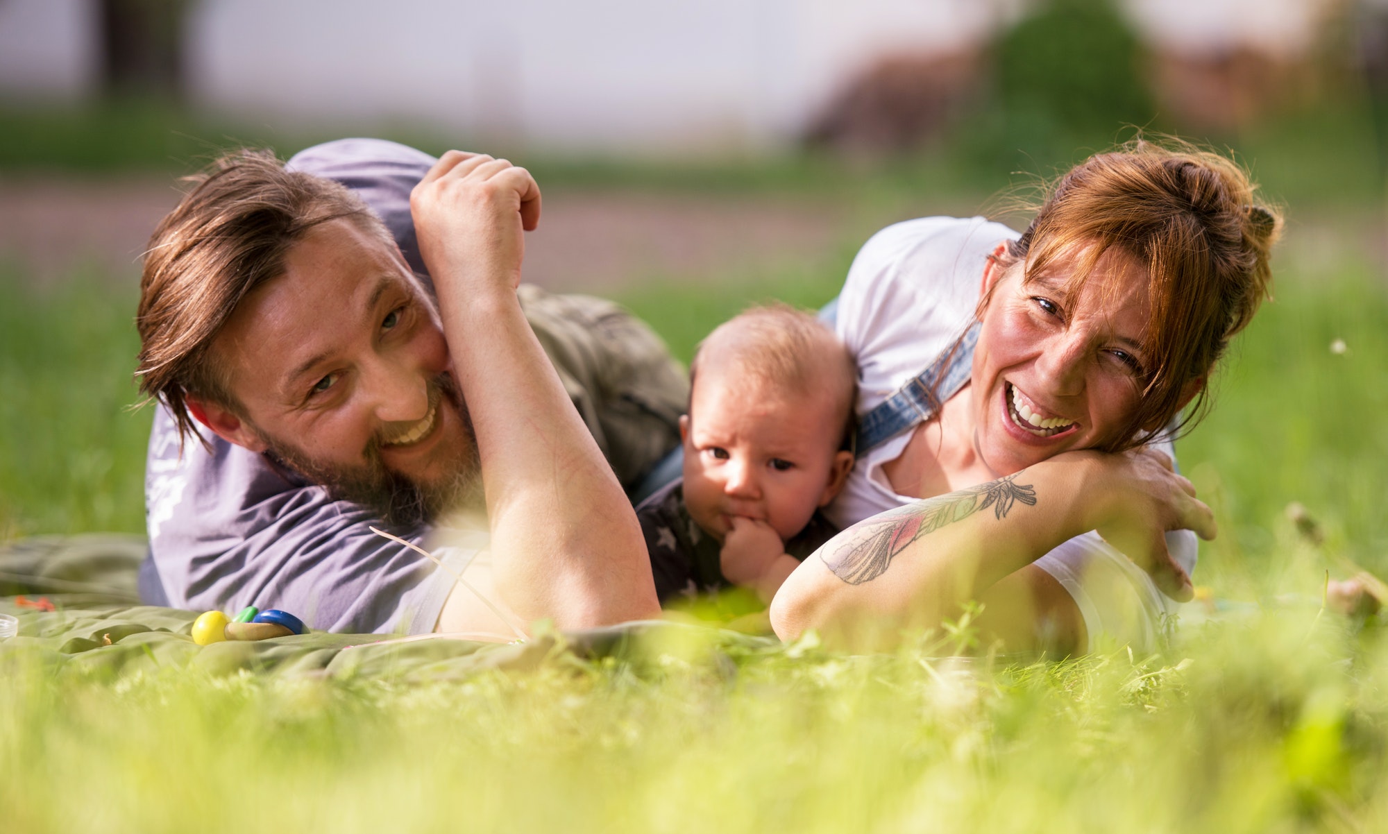 hipster family relaxing in park