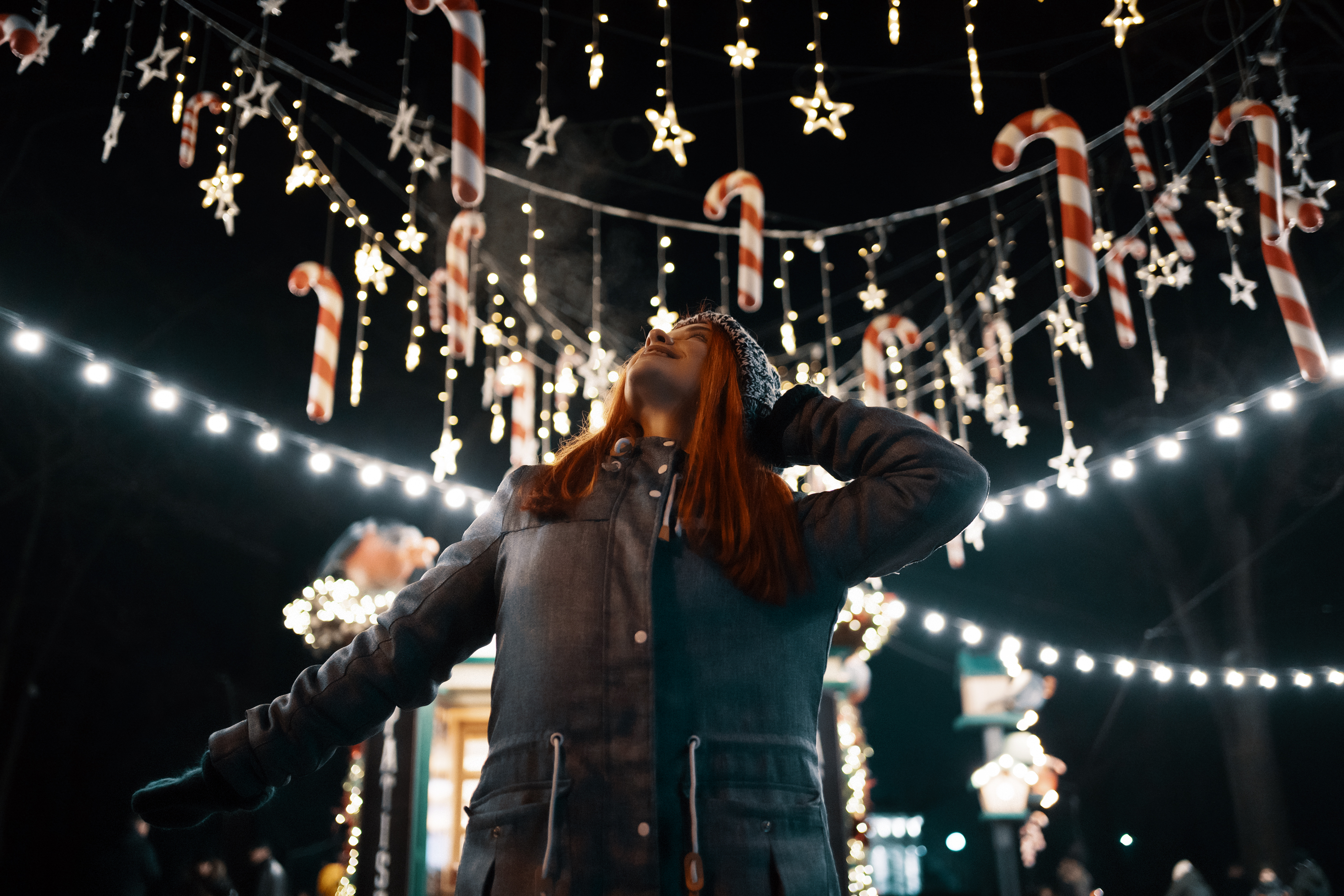 Women enjoy winter holiday lights in the evening