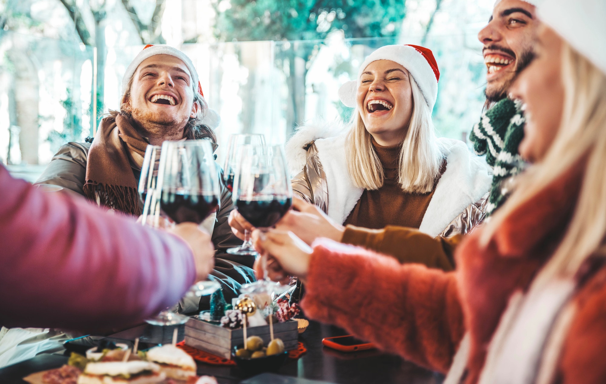 Happy family wearing santa claus hat having Christmas dinner party