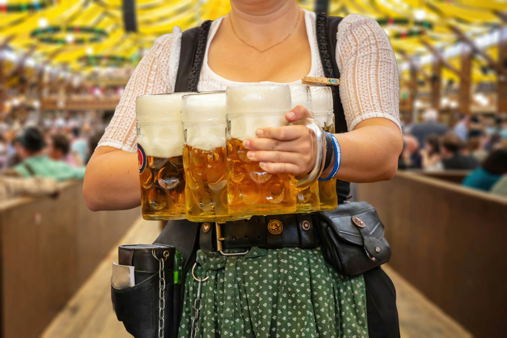 Oktoberfest, Munich. Waiter serve beer, close up. Octoberfest German festival.