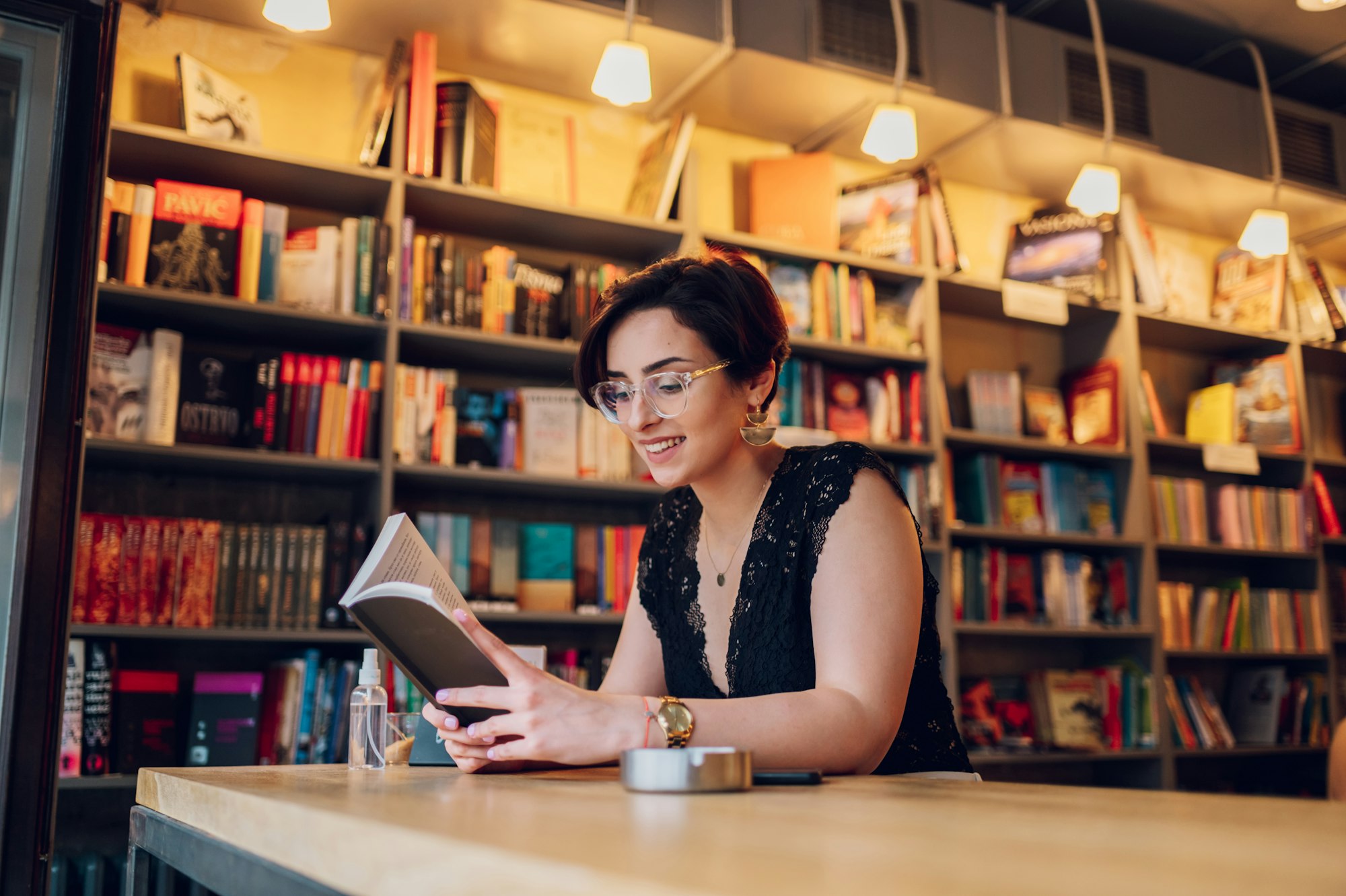 Woman reading a book while relaxing in the cafe or a bookstore