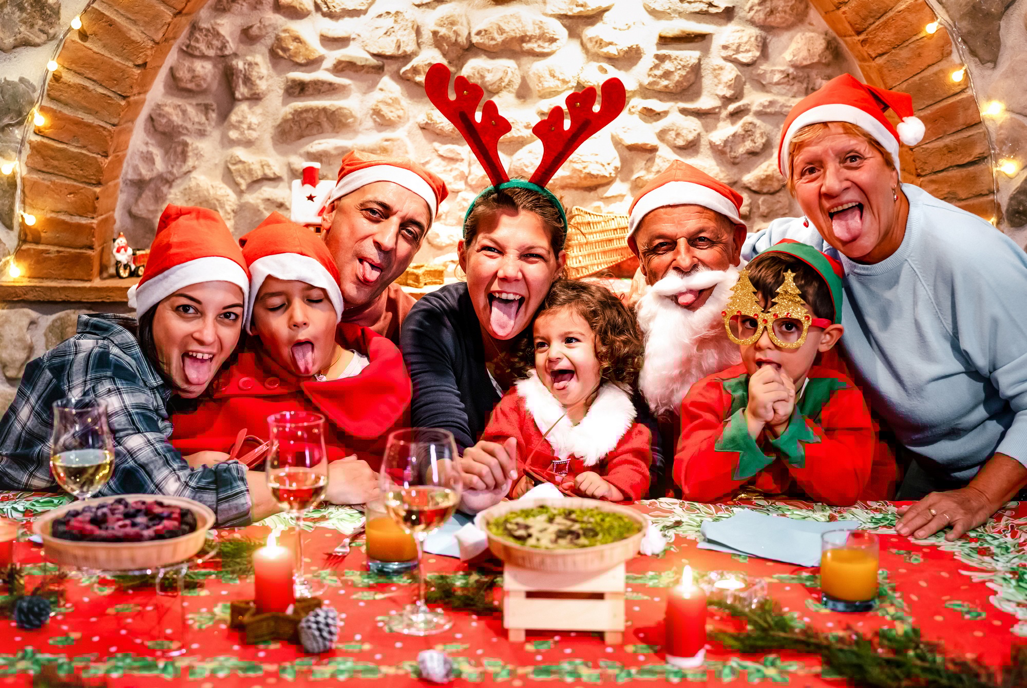 Funny selfie pic of multi generation large family with santa hats having fun at Christmas Funny selfie pic of multi generation large family with santa hats having fun at Christmas