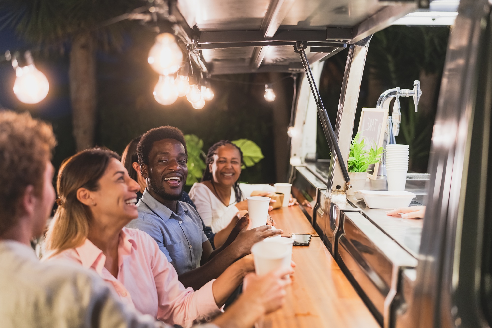 Happy multiracial people buying meal from food truck kitchen – Modern business and take away concept Happy multiracial people buying meal from food truck kitchen - Modern business and take away concept