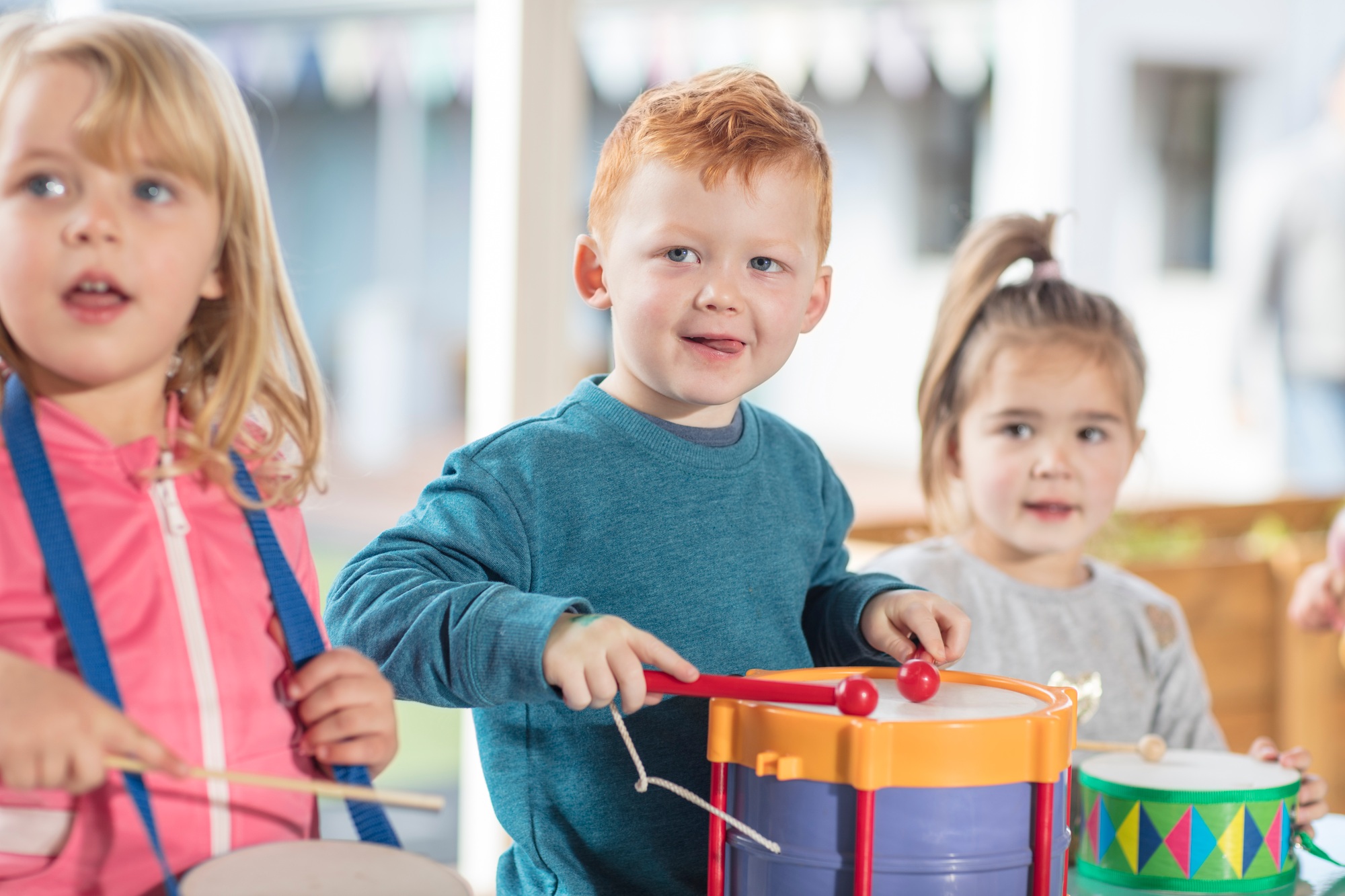 Young children playing with musical instruments