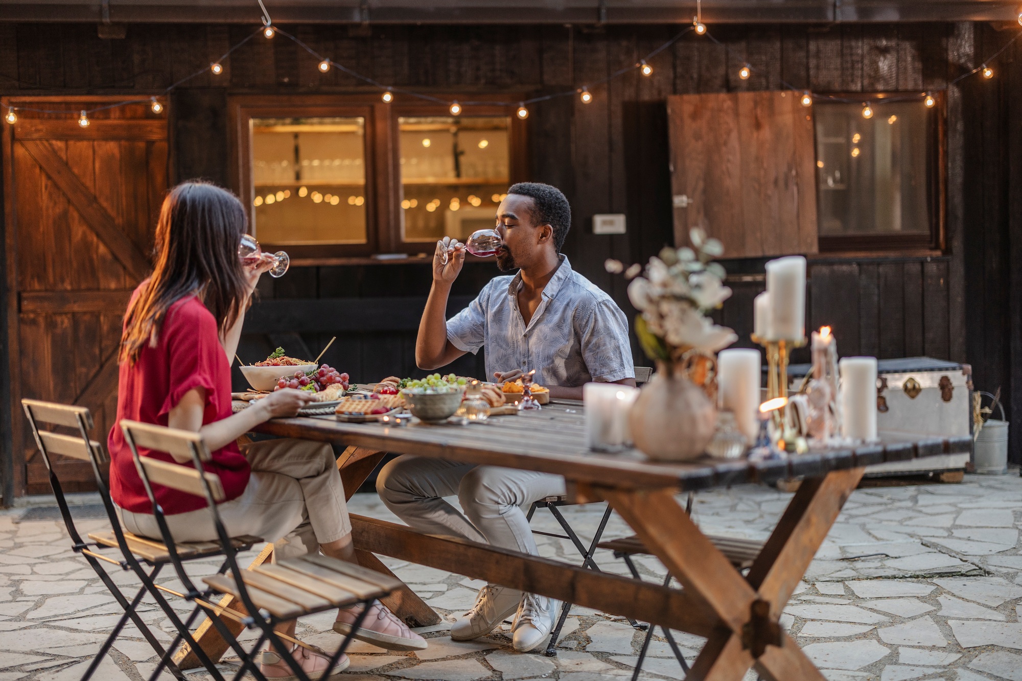 Friends enjoying wine and food at outdoor party