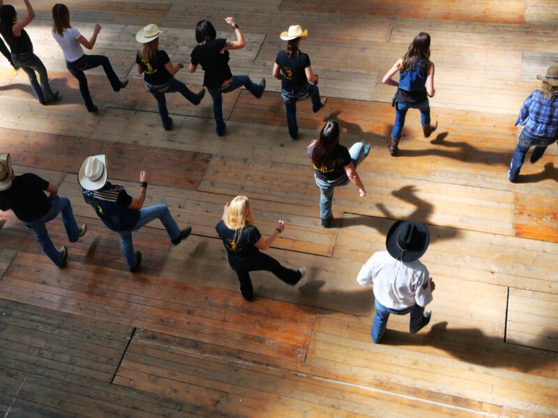 Top view of a group of traditional western folk dancing under the music